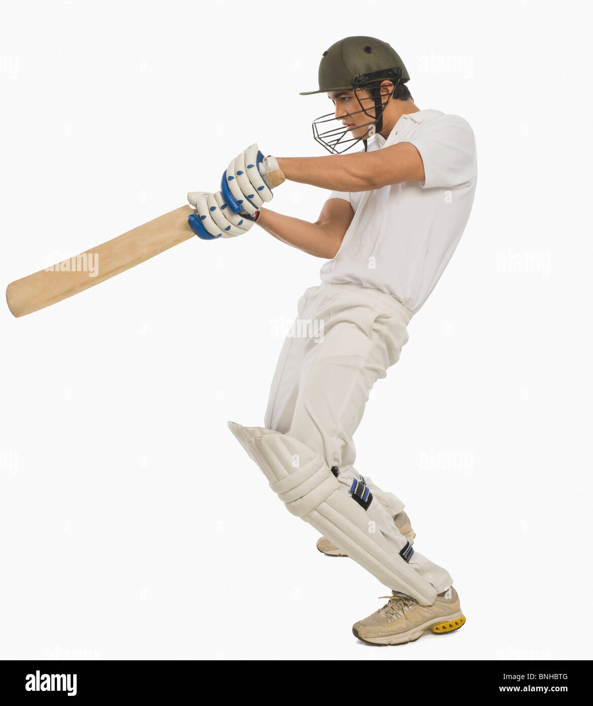 Cricket batsman playing a square cut shot Stock Photo