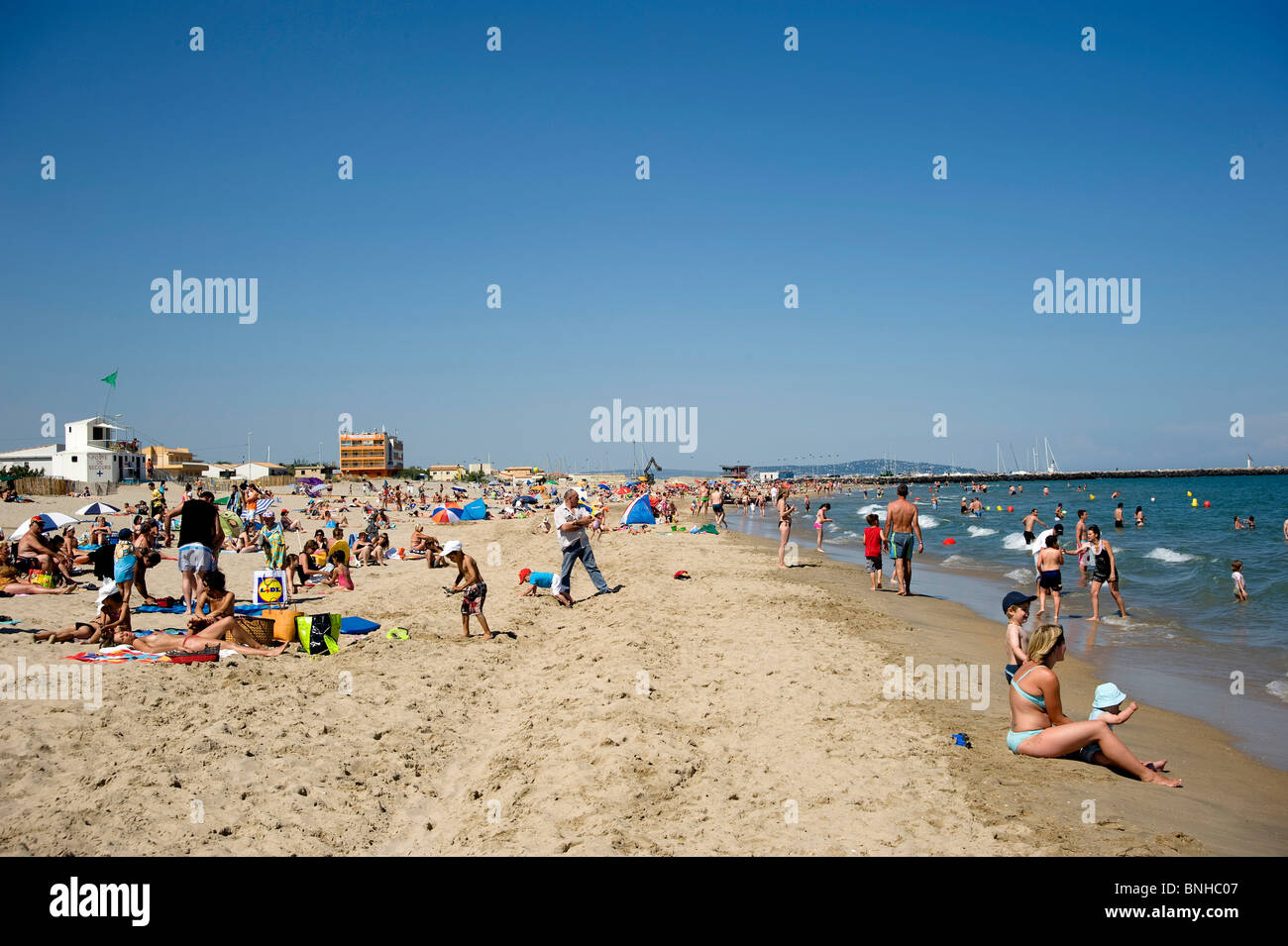 Sunbathers on a  Mediterranean beach Stock Photo