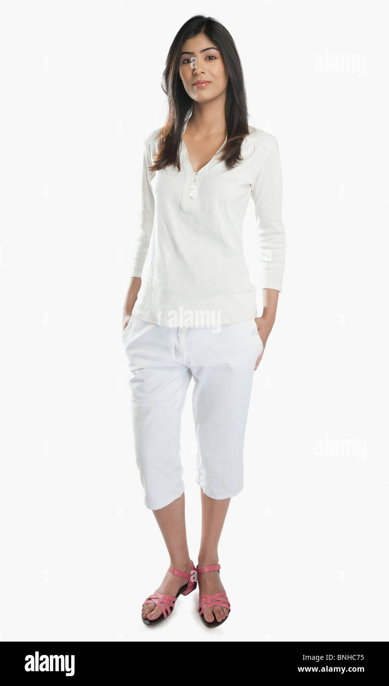 Portrait of a woman standing with her hands in pockets Stock Photo - Alamy