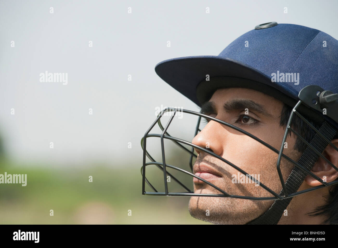 Cricket batsman wearing a helmet Stock Photo Alamy