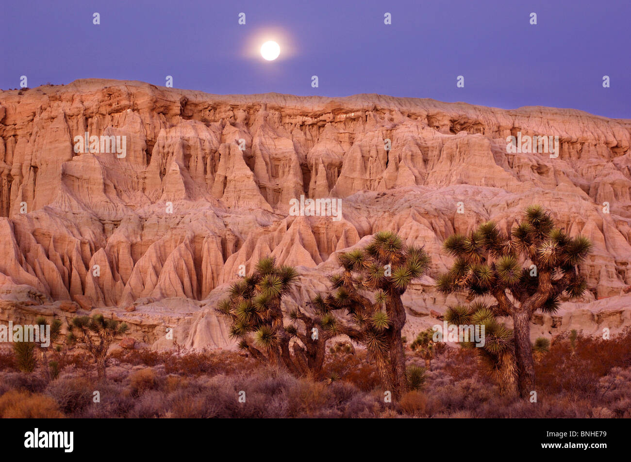 Usa California Badlands At Red Rock Canyon State Park Dawn Morning Landscape Scenery Scenic Nature Moon Joshua Trees Desert Stock Photo