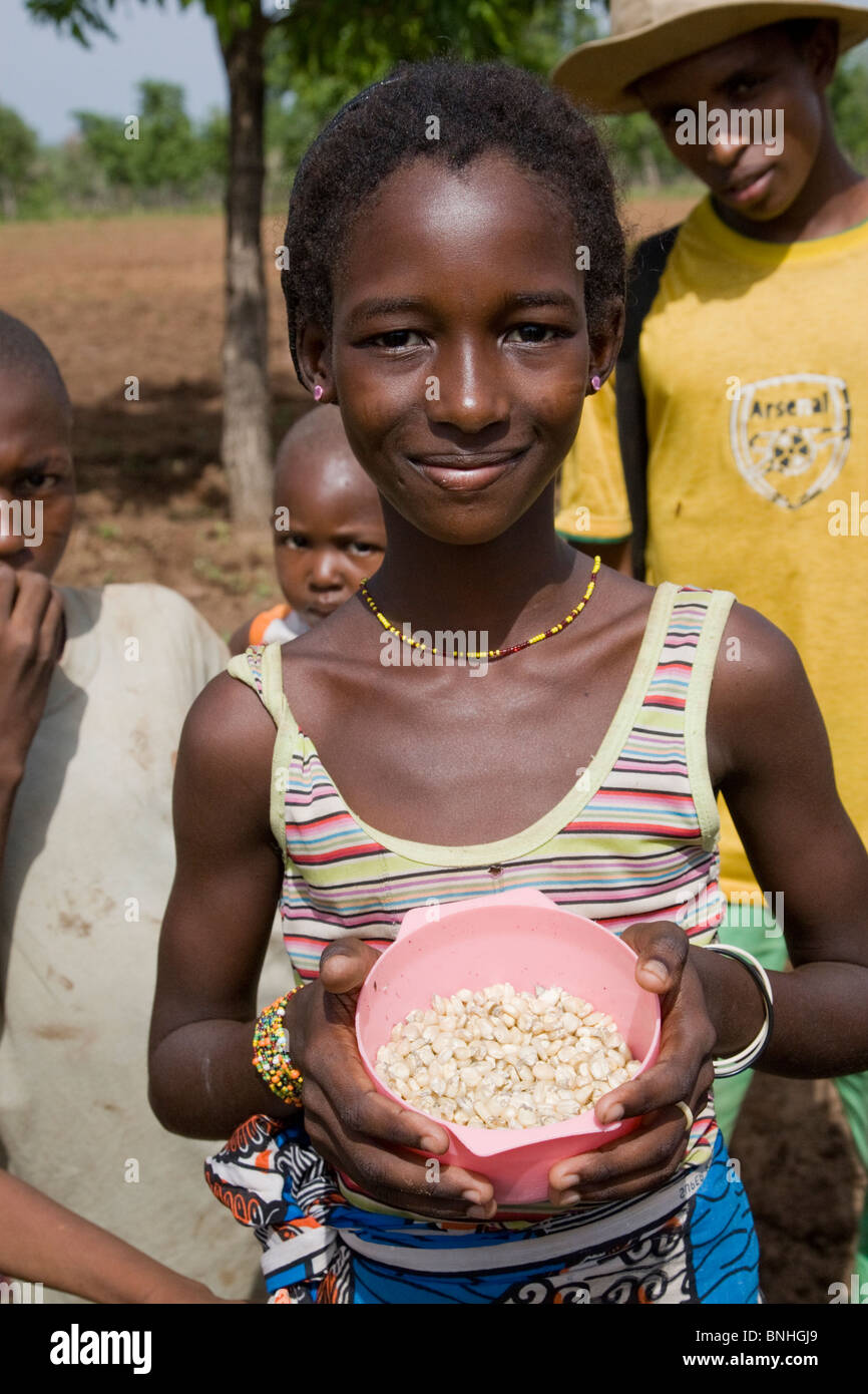A young girl helping with the sowing of the maize crop in a Fulani compound in a village in Damango district, Ghana. Stock Photo