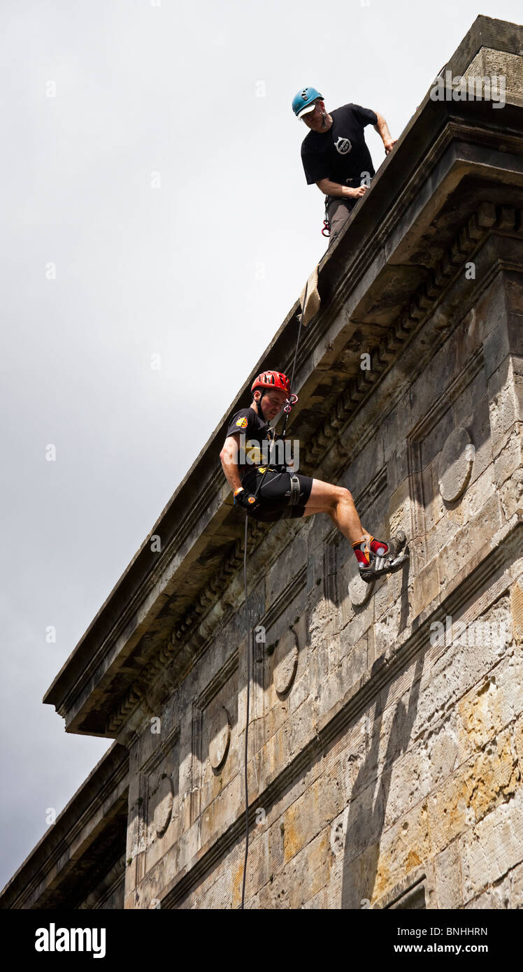 Male competitor in Rat Race Edinburgh abseiling from viaduct in extreme adventure event Scotland UK Europe Stock Photo