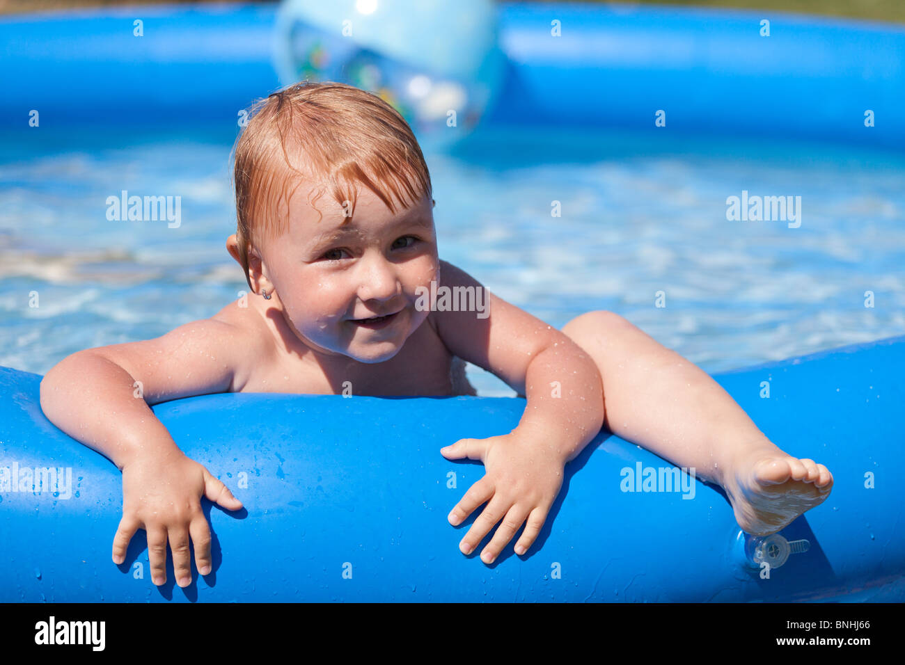 child in inflatable pool Stock Photo Alamy