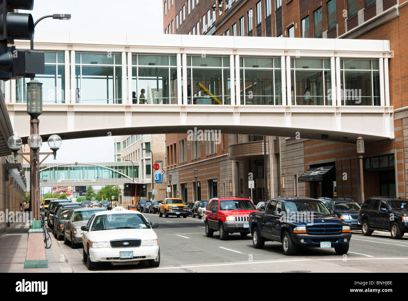 Pedestrians walk through the skyway system elevated above street level in downtown Minneapolis. Stock Photo