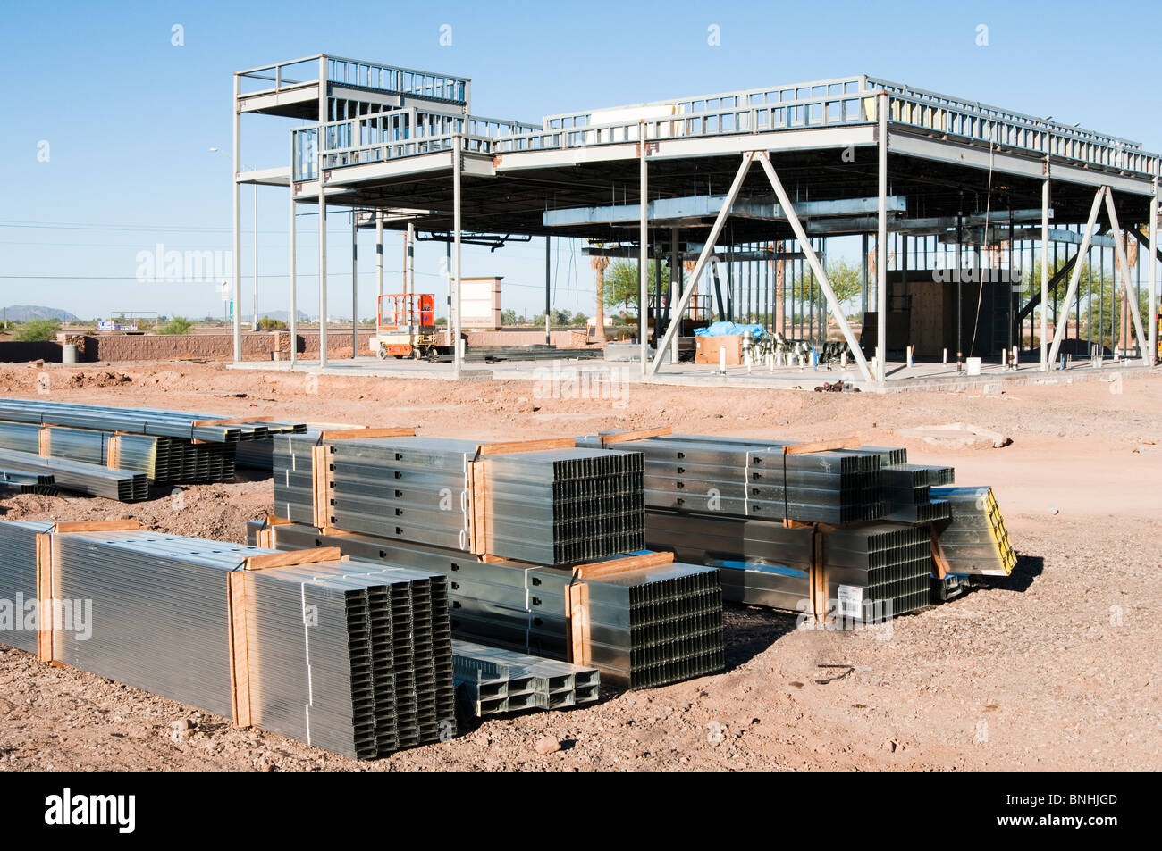Steel beams are stacked on the construction site for a commercial