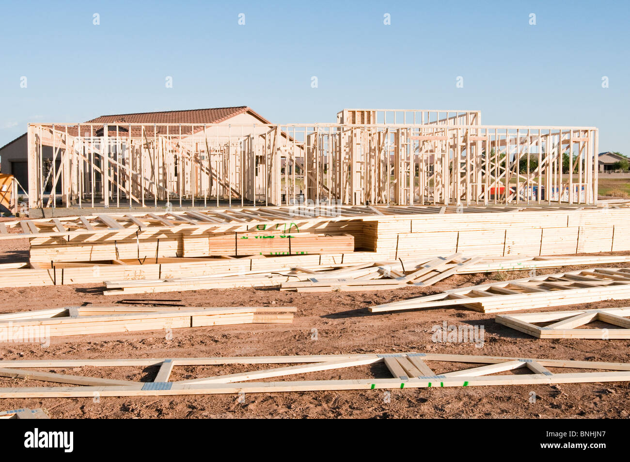 Building materials are stacked on the construction site for a new wood frame house being built in Arizona. Stock Photo