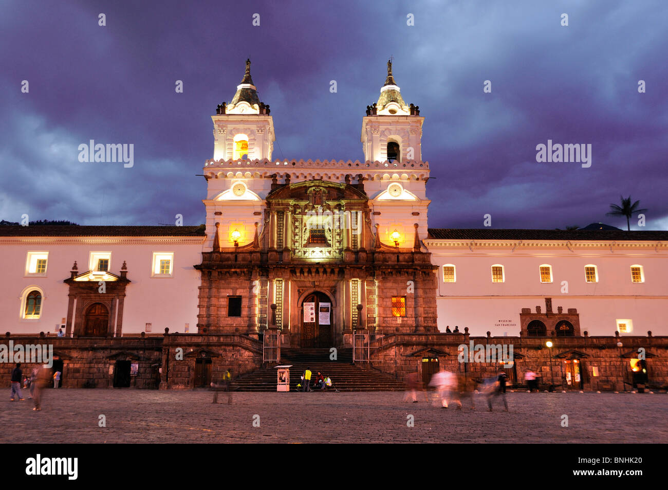 Ecuador Monasterio San Francisco Church Old town Quito city historic square people dusk twilight night architecture illuminated Stock Photo