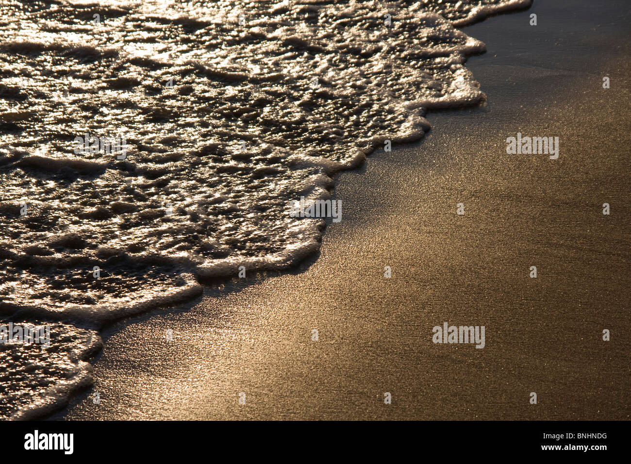 Sea tide sweeping across Pefkos Beach, Rhodes, Greece. Stock Photo