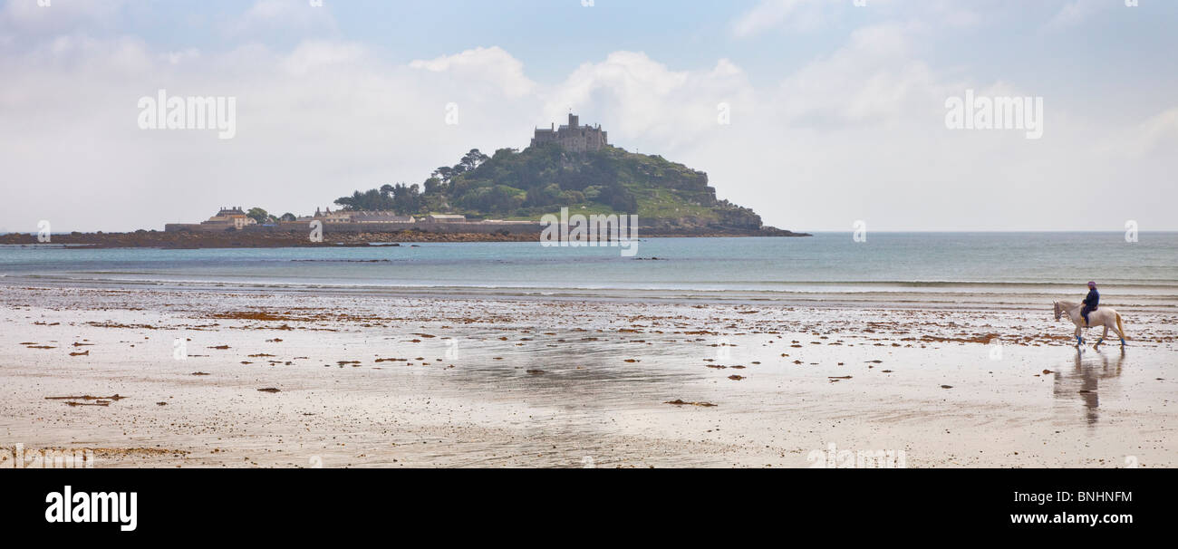 View of St Machaels Mount, beach scene with a lone horse rider, Truro, Cornwall, Stock Photo