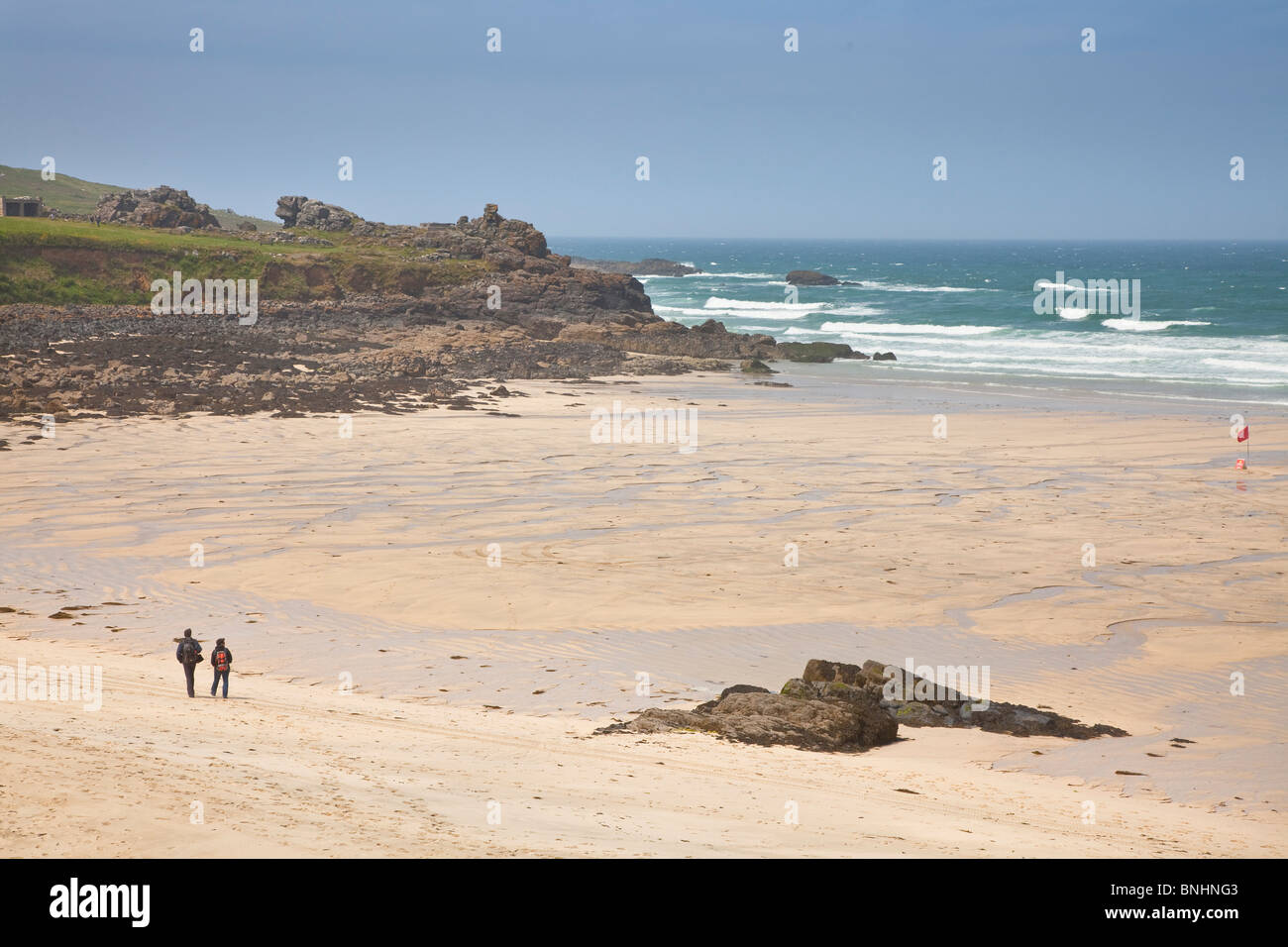 North Cornwall coast, beach scene, St Ives, two walkers Stock Photo