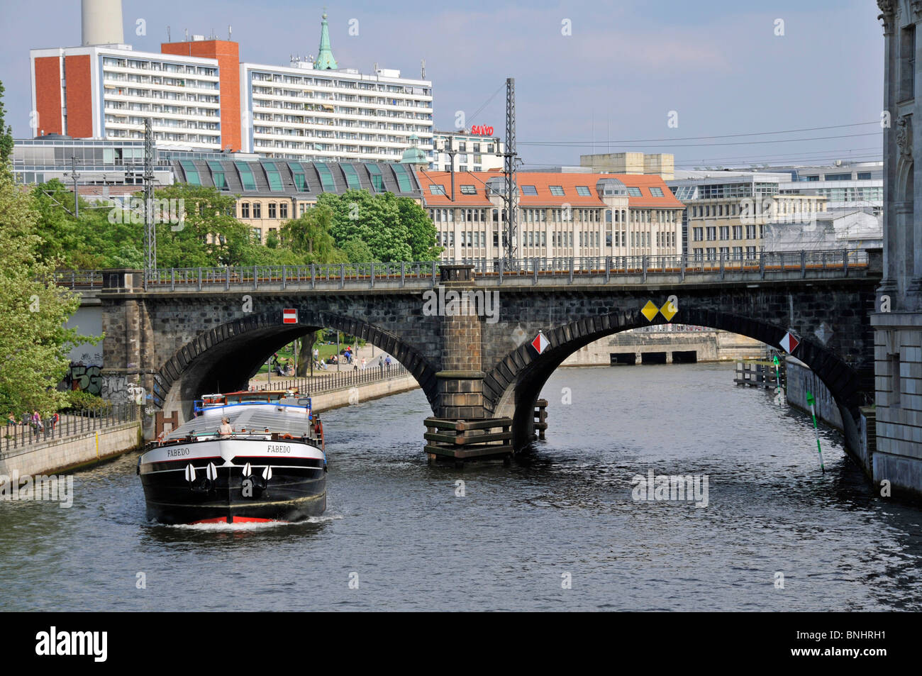 Nikolaiviertel river Spree Berlin city Germany Europe Railroad bridge Railway Ship boat Canal Buildings Stock Photo