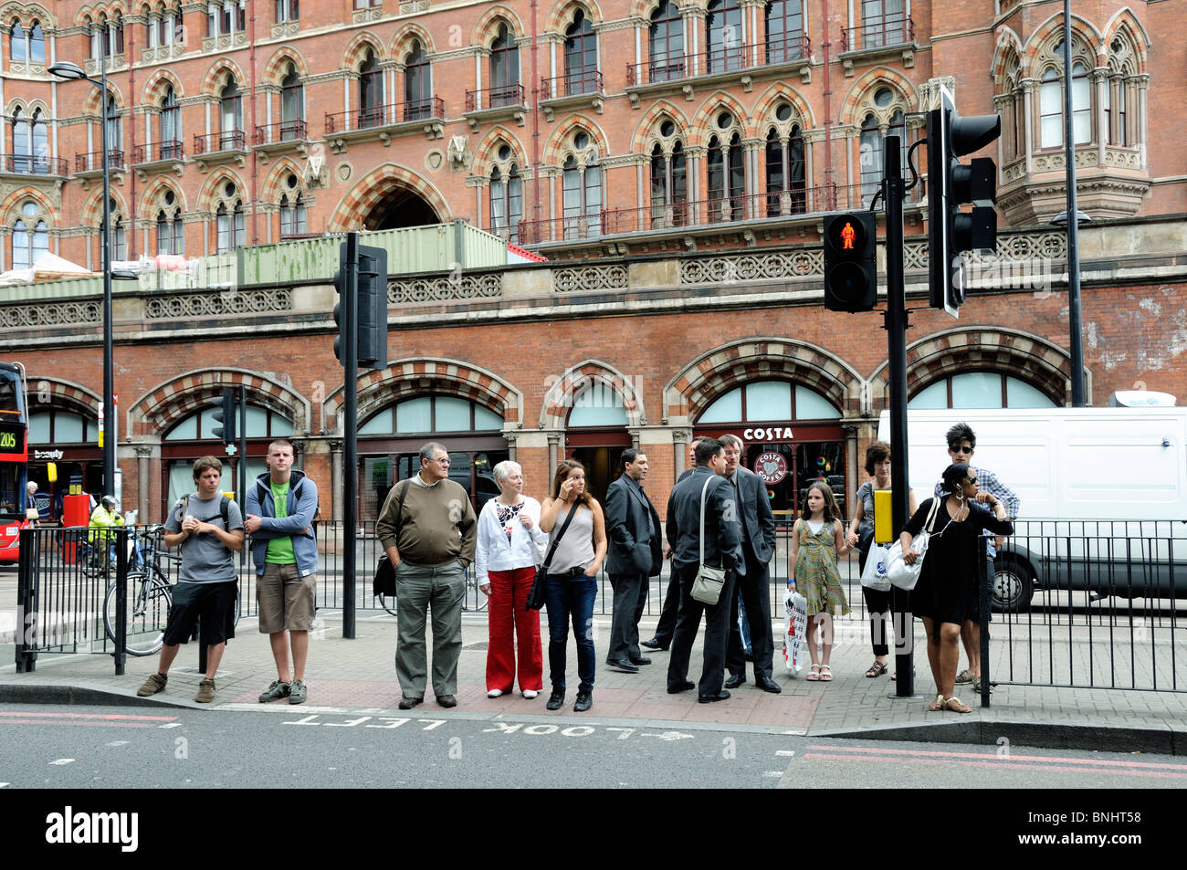 Pedestrians crossing Euston Road in front of St. Pancras Station, London, England UK Stock Photo