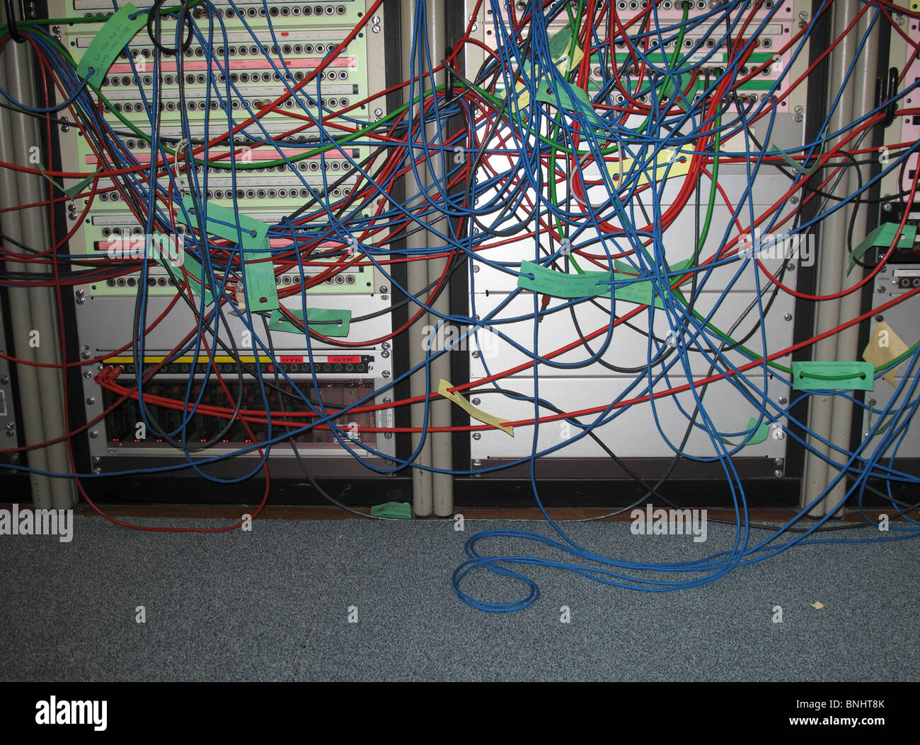 messy colorful wires in front of server Stock Photo