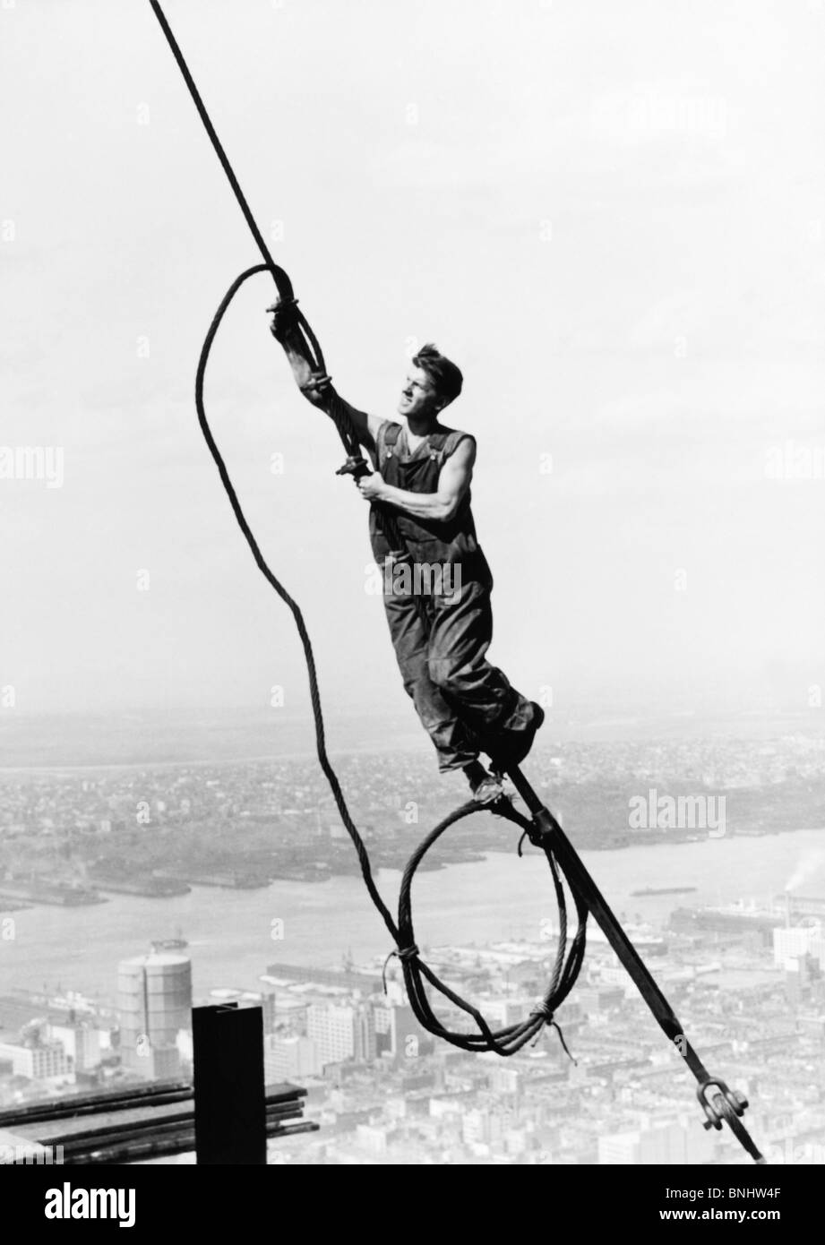 Icarus Empire State Building by Lewis Hine working 1920 industry work worker man construction site rope cable dizzy dizzying Stock Photo