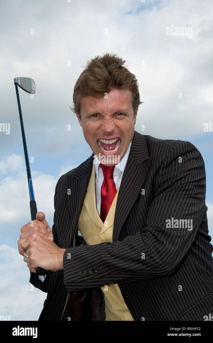 Man businessman business outside outdoor outdoorssport hobby pastime gulf golf golf club suit play aggressively grimace annoys Stock Photo