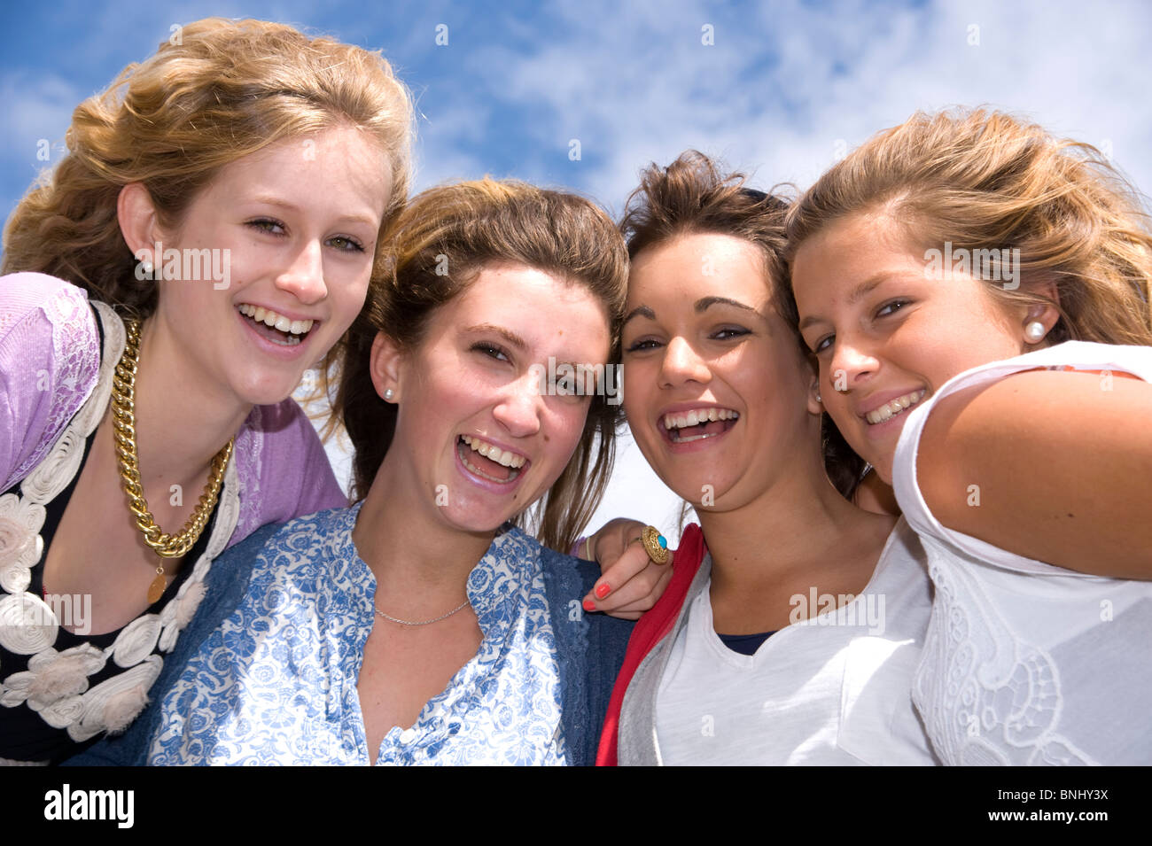 15 16 4 girl teenager in general normally scenery day four friends amusingly happily heads heads puddles outdoors outside park Stock Photo