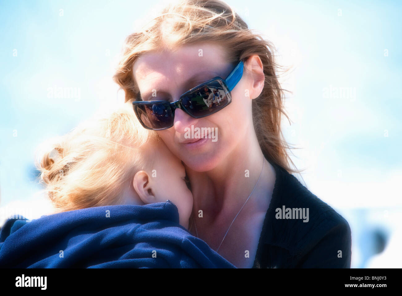 Woman 30 child affection nearness embrace mother sunglasses portrait tiredly Outside Outdoors baby Stock Photo