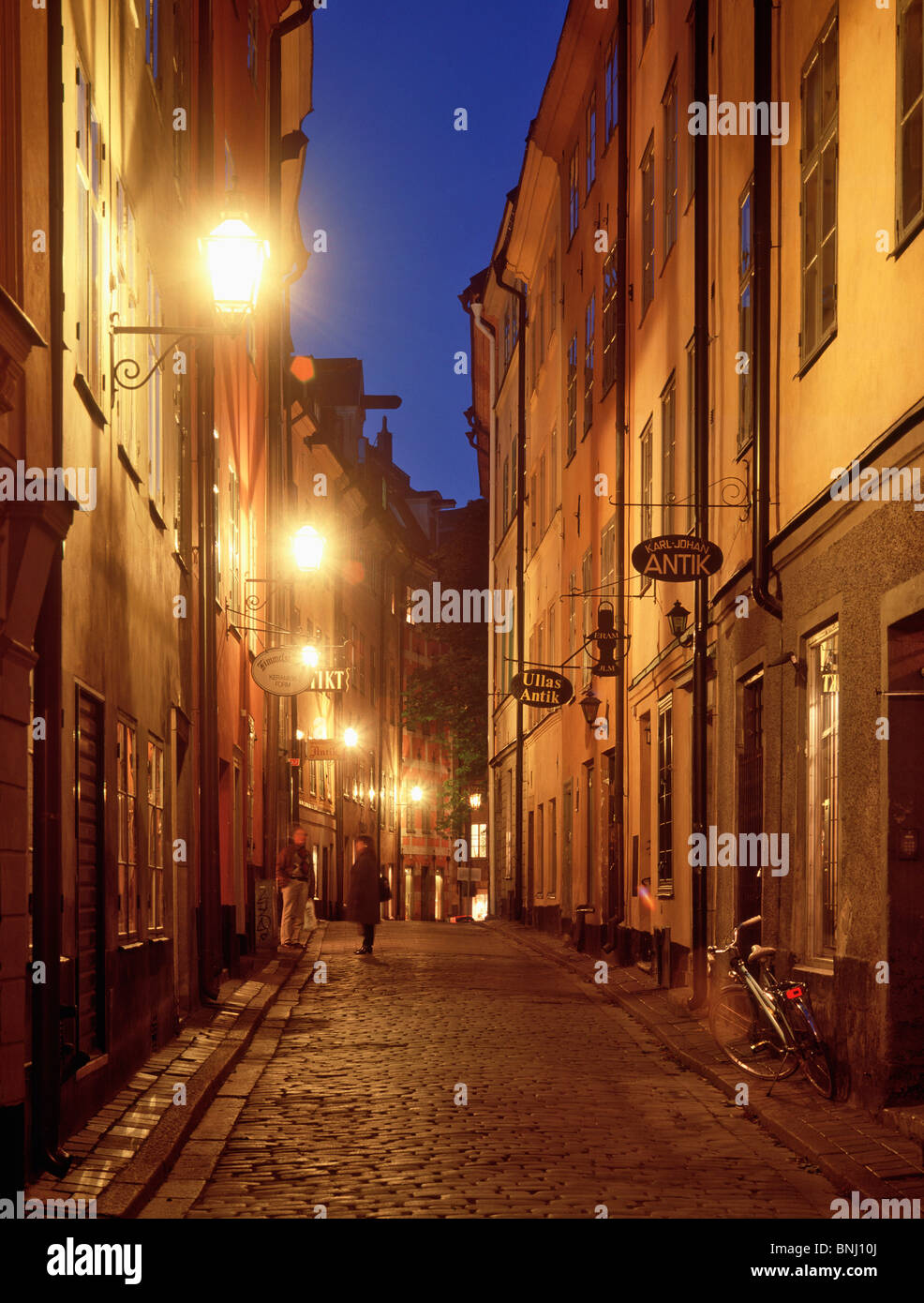 Sweden Scandinavia Stockholm Old Town lane alley lights in evening cobblestones night Stock Photo