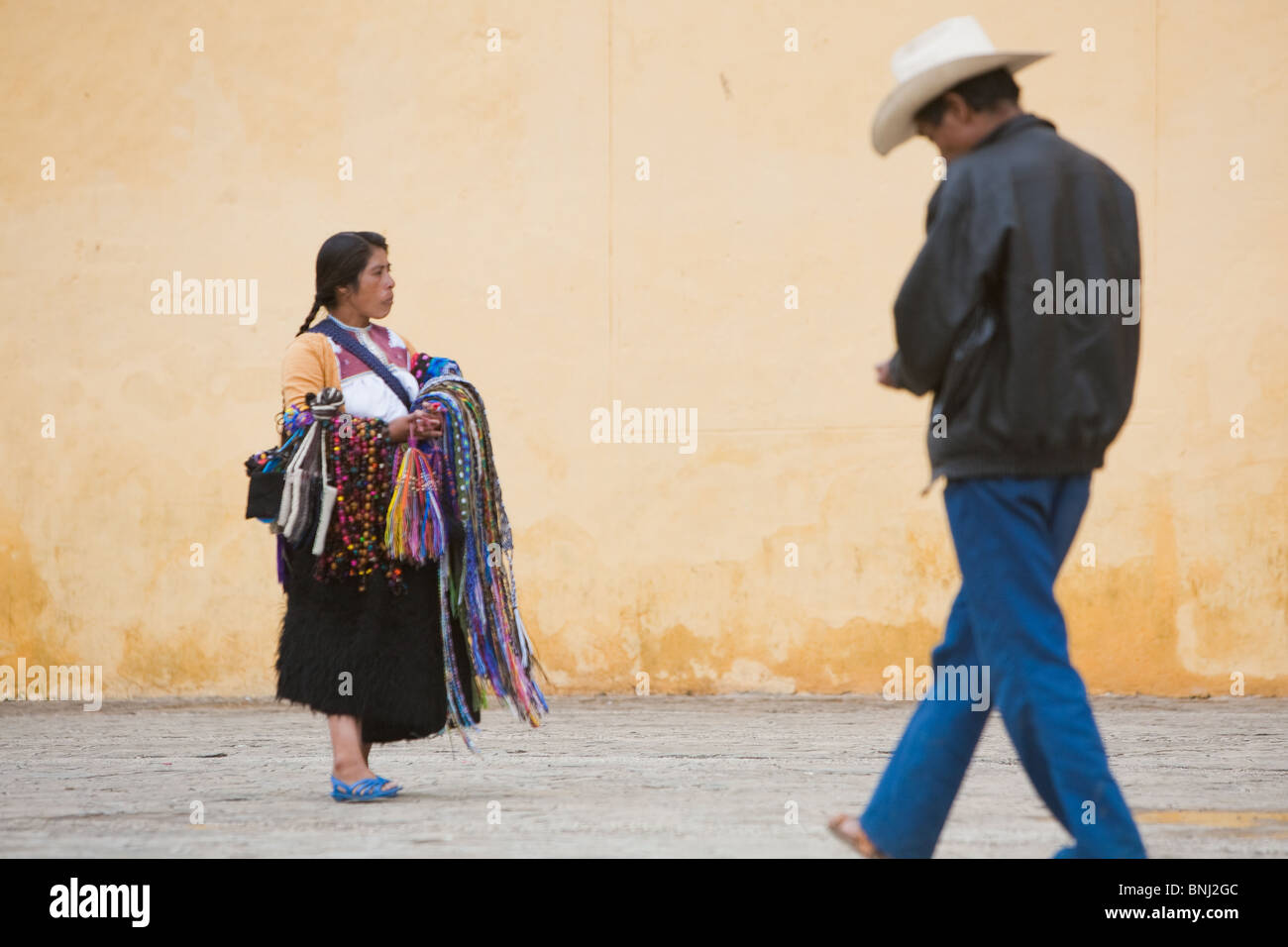 An indigenous woman hand-woven belts seller walking around the zocalo in San Cristobal de las Casas, Chiapas, Mexico. Stock Photo