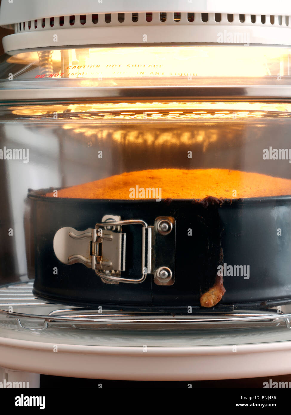 Sponge cake cooking in a halogen oven Stock Photo Alamy
