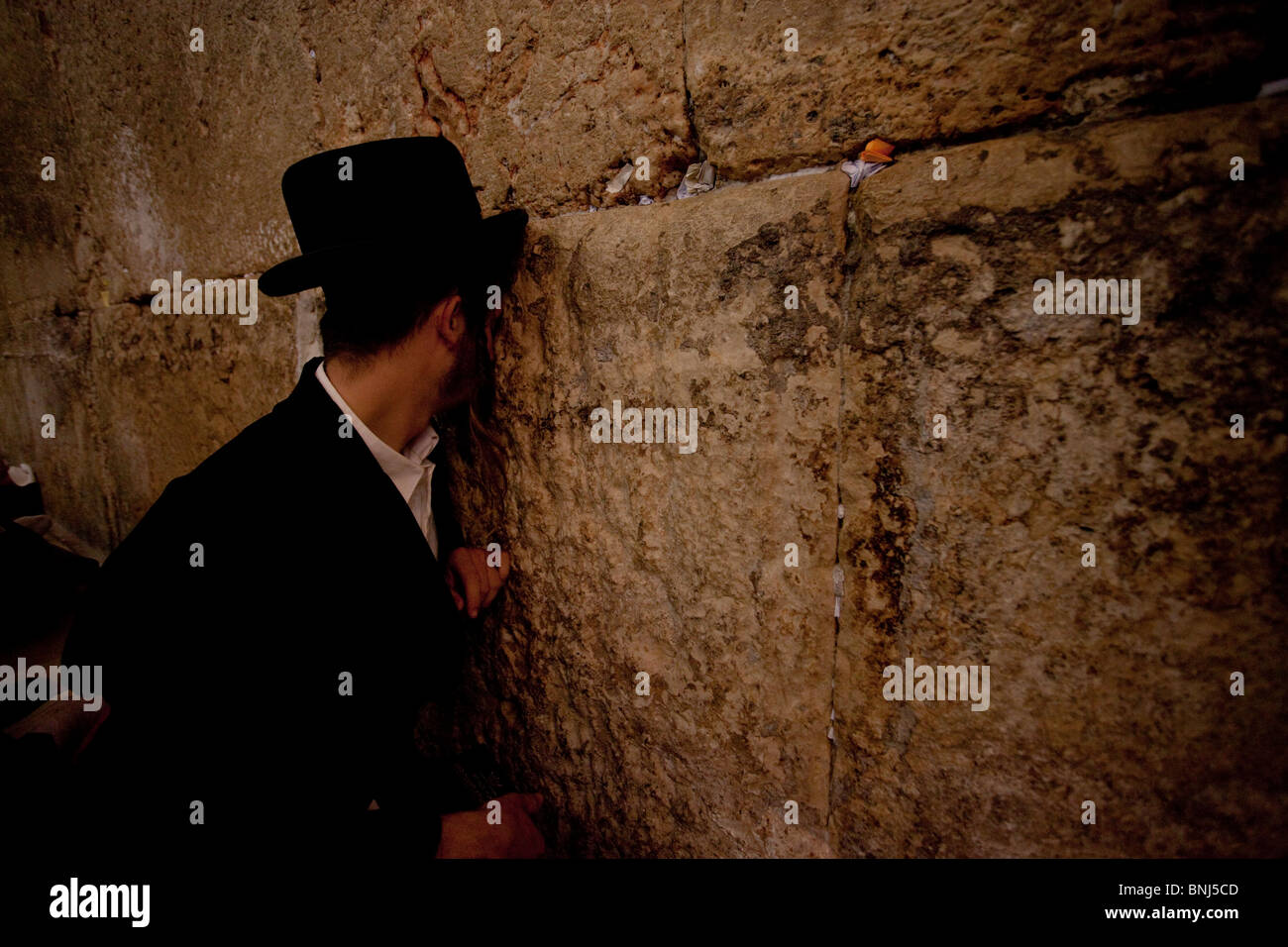 Ultra orthodox Jewish men mourning in the Western or wailing wall on Tisha B'Av feast in the Old city East Jerusalem Israel Stock Photo