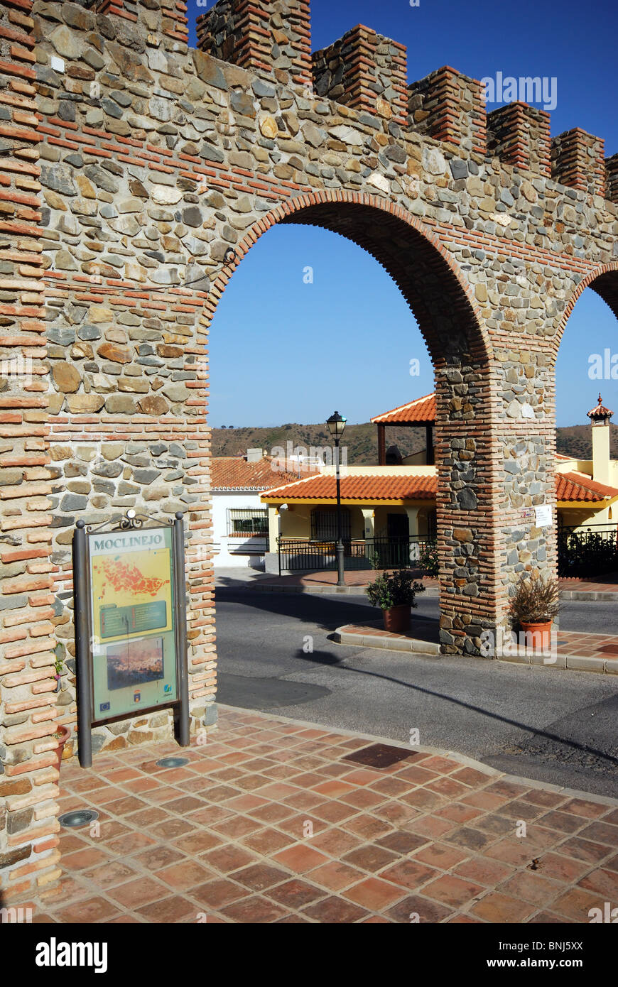 Castle style entrance arch, Whitewashed village (pueblo blanco), Moclinejo, Costa del Sol, Malaga Province, Andalucia, Spain. Stock Photo