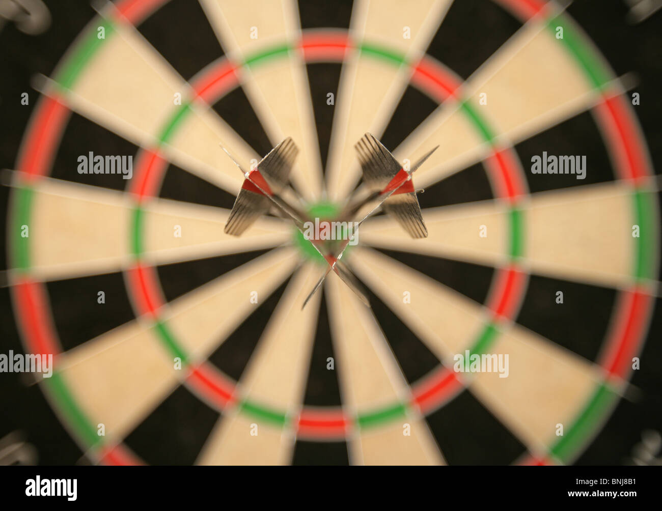 Three darts in bullseye on dartboard Stock Photo Alamy