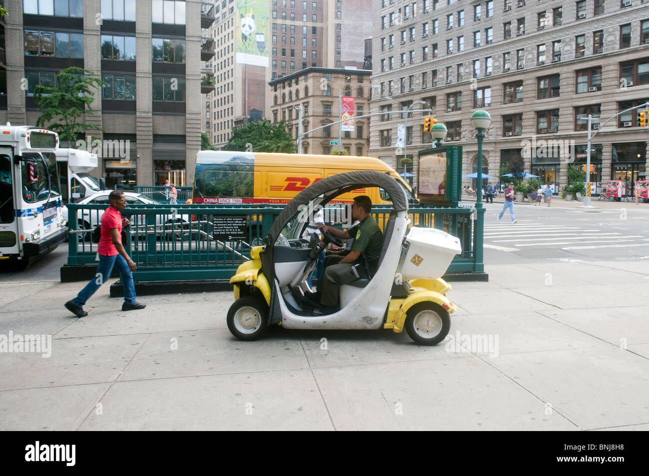 NYC Department of Parks and Recreation employees scoot around in a Global Electric Motorcars (GEMs) Stock Photo