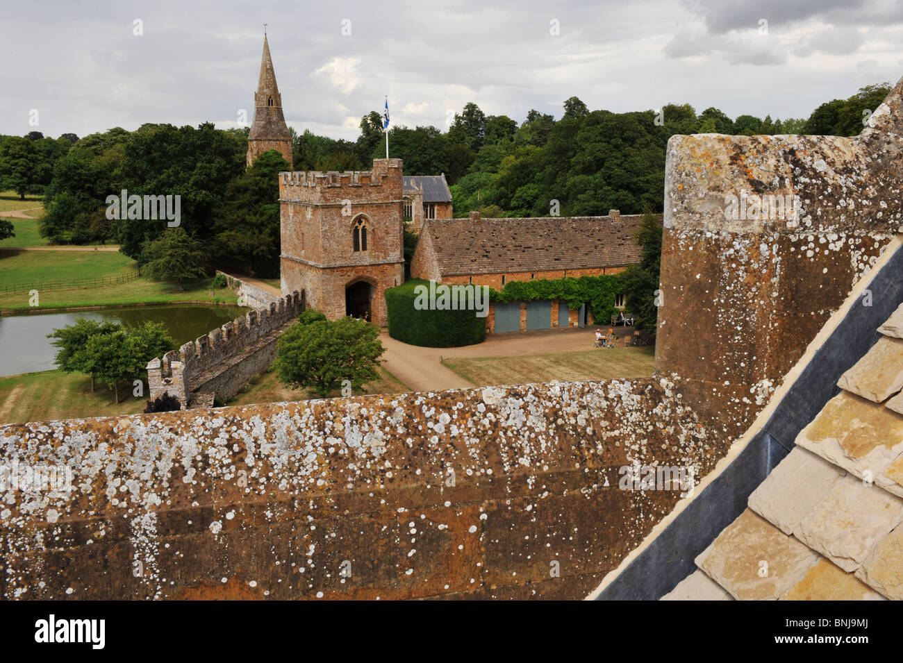 Broughton Castle near Banbury in Oxfordshire. From the roof of the main building  overlooking the gatehouse and church beyond Stock Photo