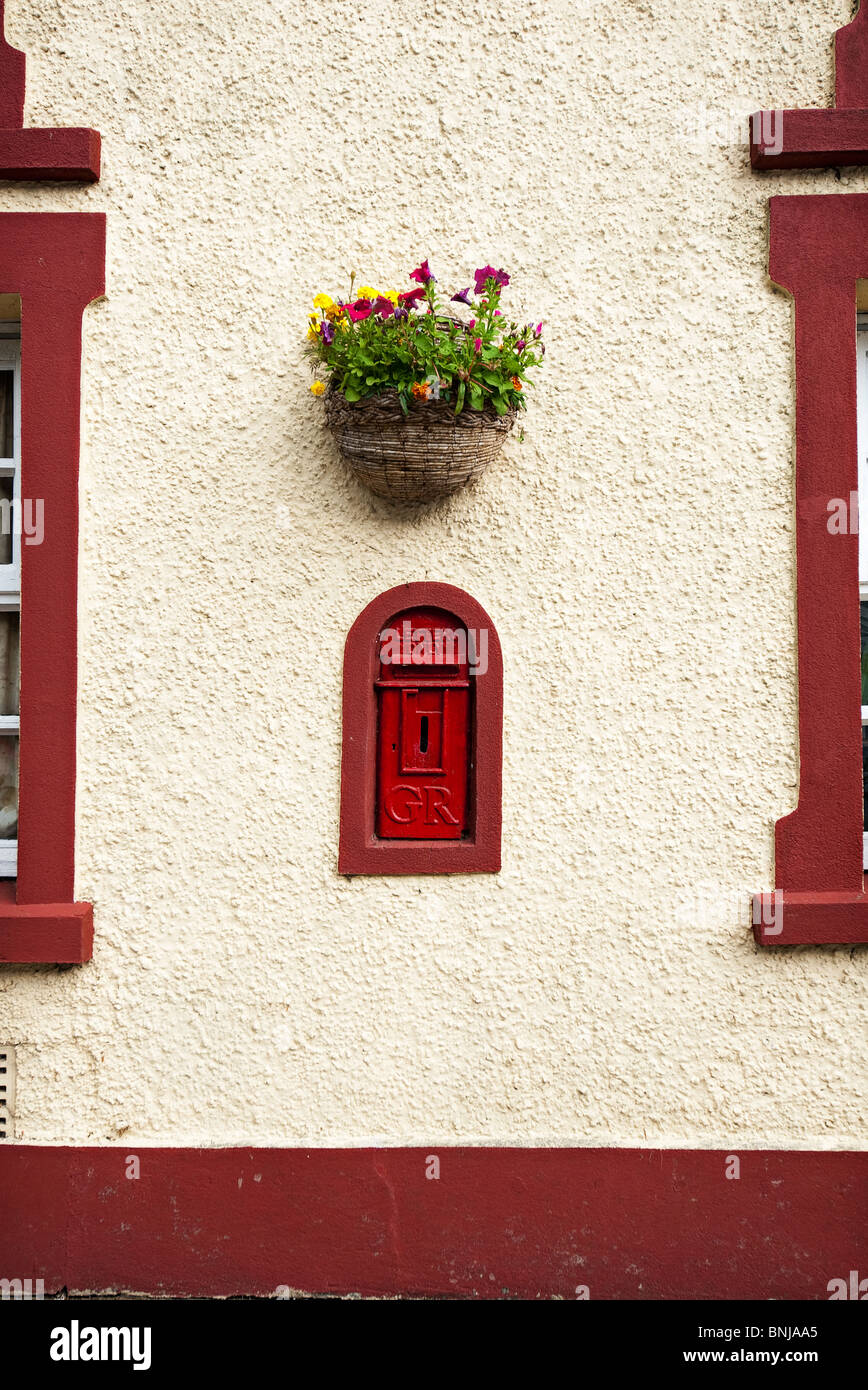 red post box in the wall of a house in criben west wales Stock Photo