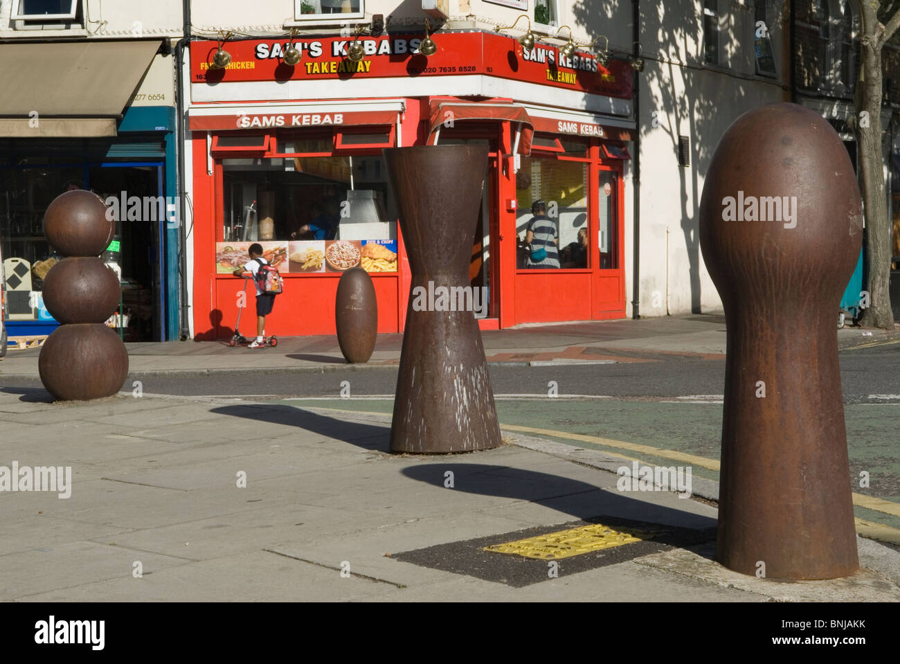 Peckham Rye South London UK. Anthony Gormley street furniture sculpture bollards Bellenden Road SE15 HOMER SYKES Stock Photo