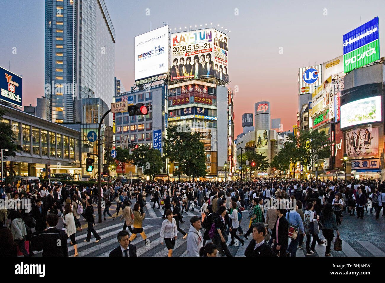 Japan Asia Tokyo town city Shibuya District in the evening pedestrian traffic passer-by building construction neon lights crowd Stock Photo