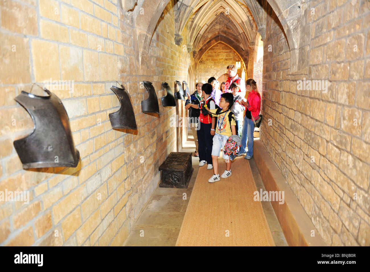 Visitors explore the corridors and historic displays at Broughton Castle near Banbury in Oxfordshire UK Stock Photo