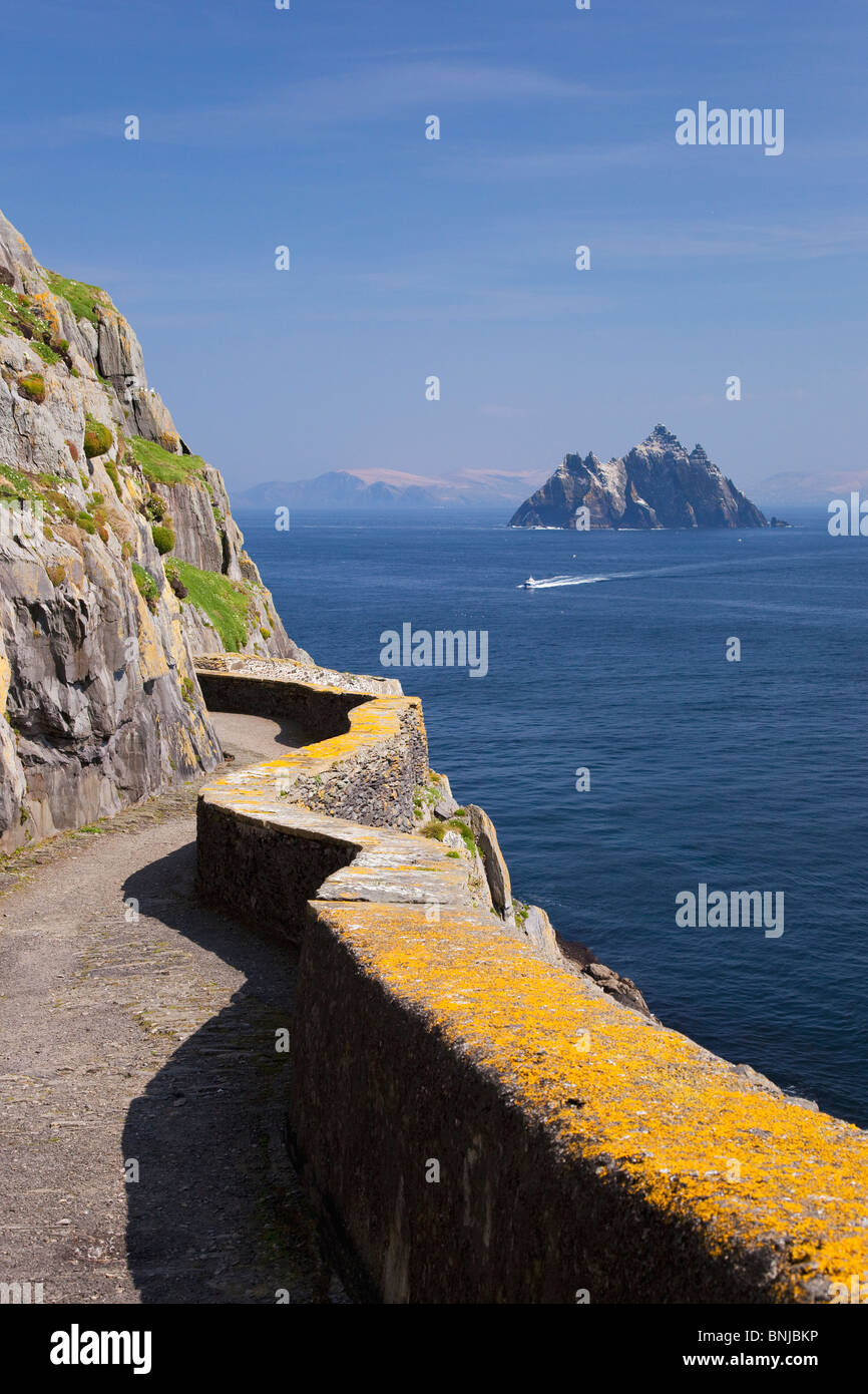 Fishing boat bringing tourists past Little Skellig to Skellig Michael County Co. Kerry in spring sunshine Republic of Ireland Ei Stock Photo