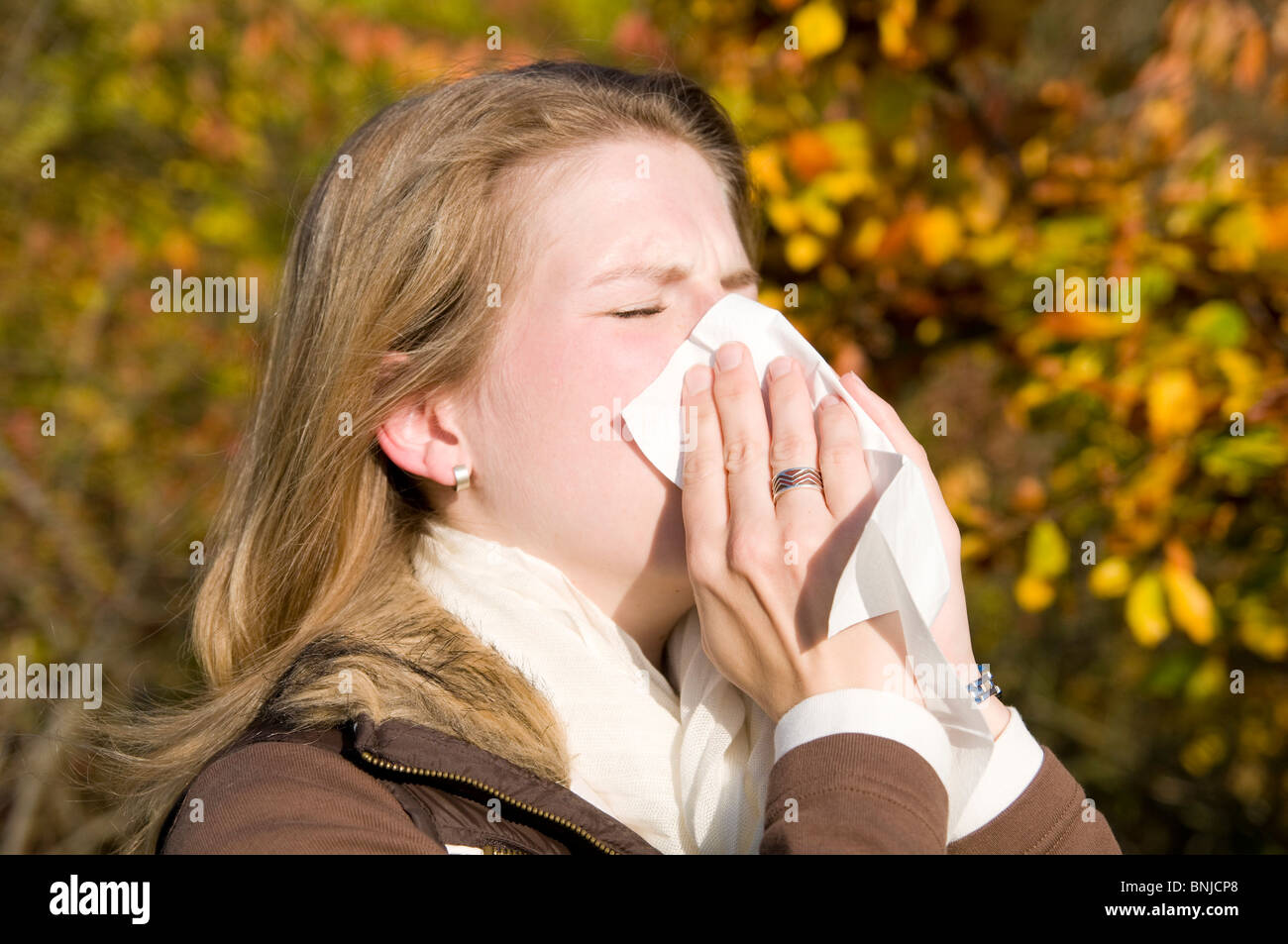 Woman autumn ill sick allergy a cold blond catches cold influenza handkerchief, Stock Photo