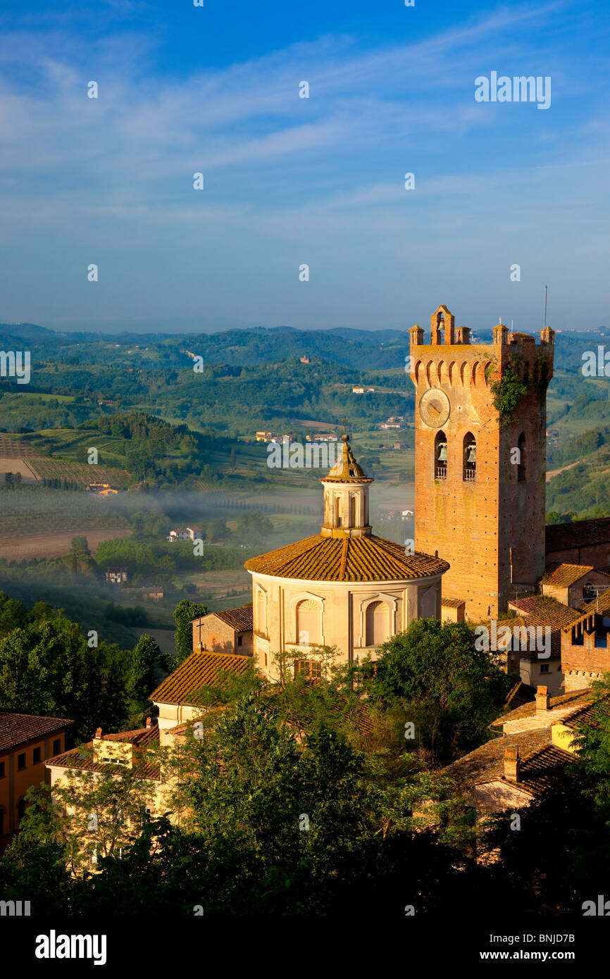 Morning mist laying in the valley below the duomo and medieval town of San Miniato, Tuscany Italy Stock Photo