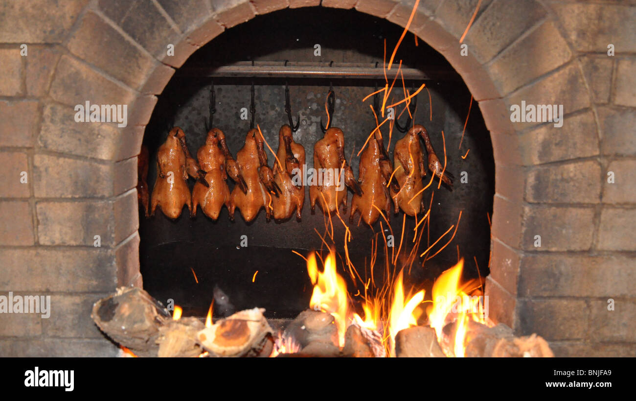 Peking Duck in roasting in wood burning oven in Beijing, China Stock