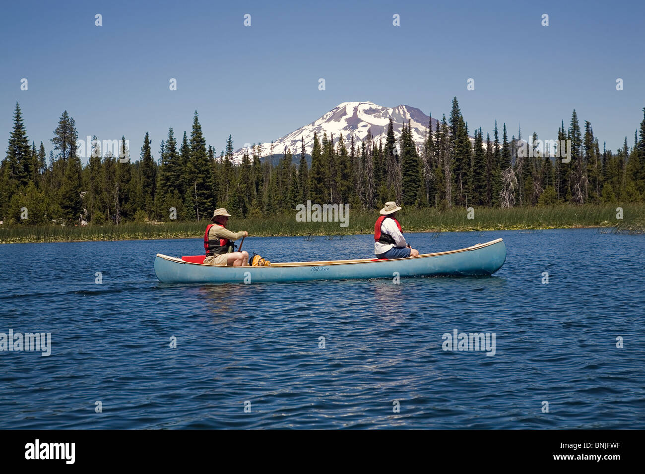 Senior citizens paddle a canoe on Hosmer Lake along the Cascade Lakes