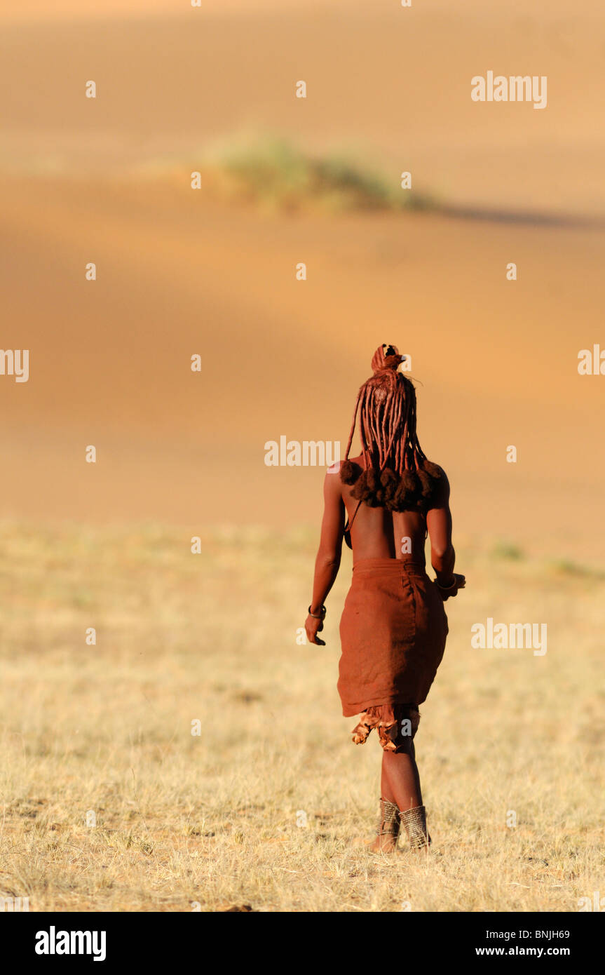 Himba people local locals natives native Kaokoland Kunene Region Namibia Africa woman one walking Stock Photo
