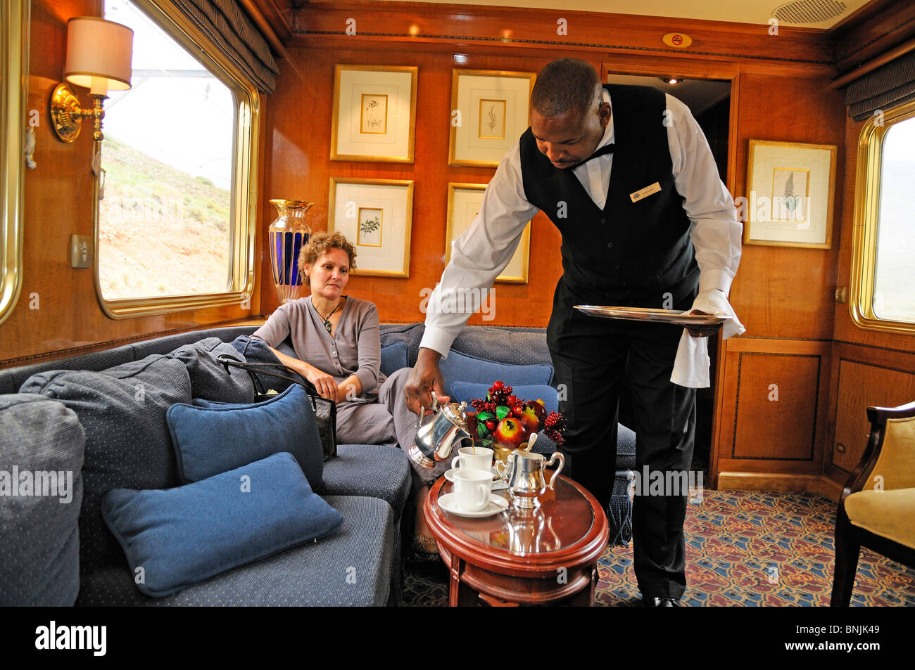 Serving Afternoon Tea Blue Train Private train from Cape Town to Pretoria South Africa railway railroad luxury travel traveling Stock Photo