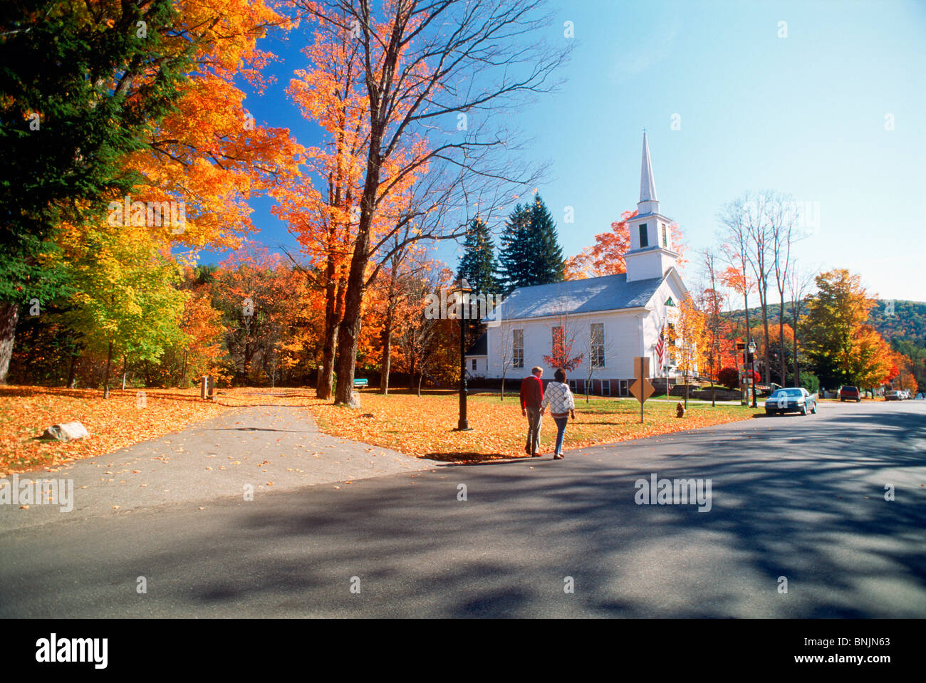 Couple near town church with fall foliage at Grafton, Vermont in New