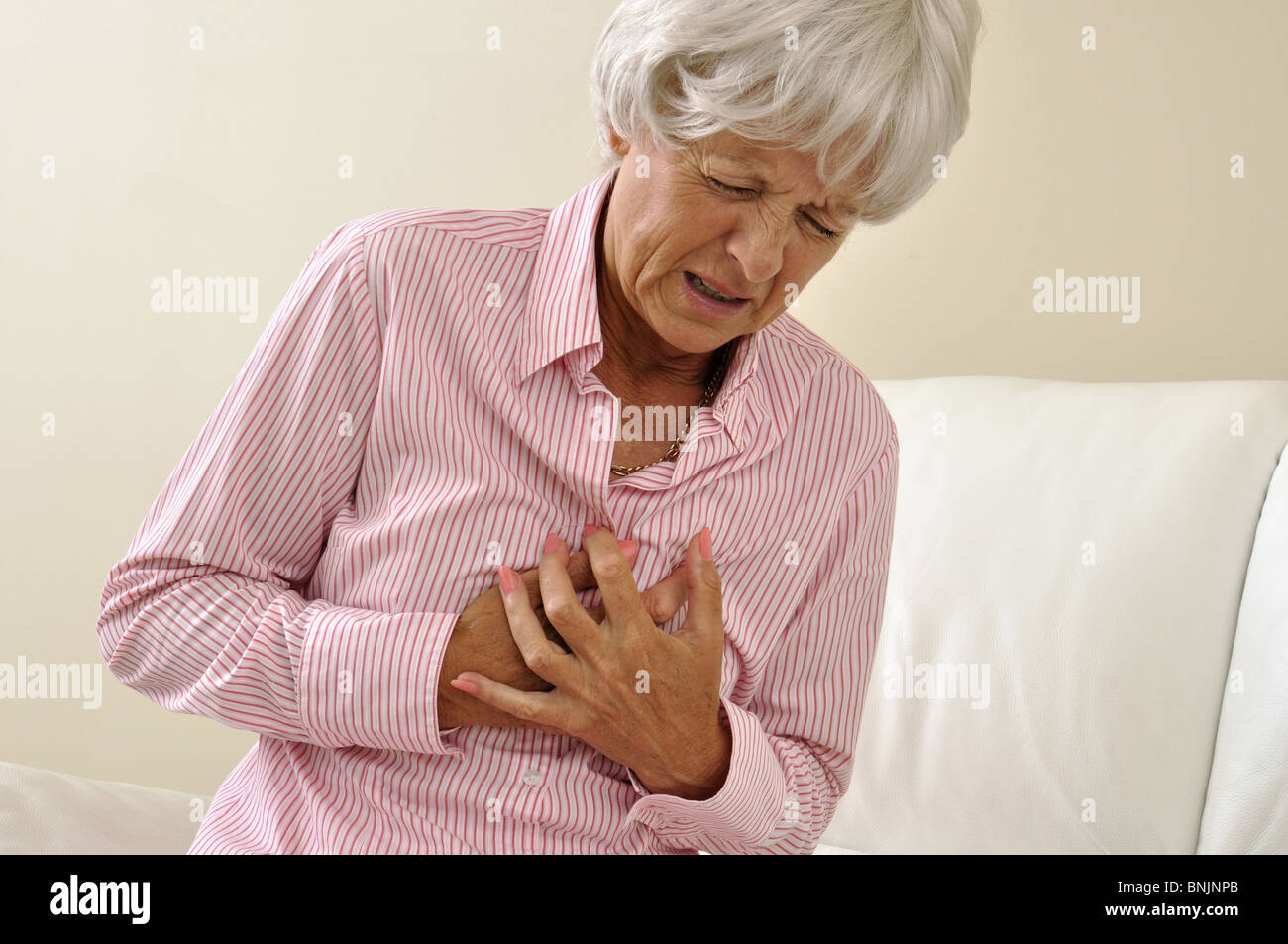 Indoors Indoor Woman Senior Mature Angina Heart Pain Old Sick Myocardial infarction Heart attack Stock Photo