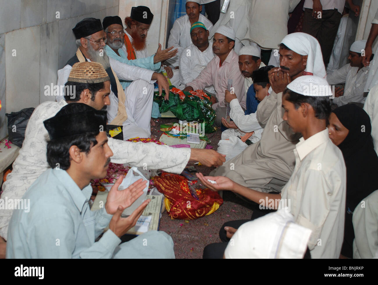 Muslims perform religious rites in Dargah during Urs. Stock Photo