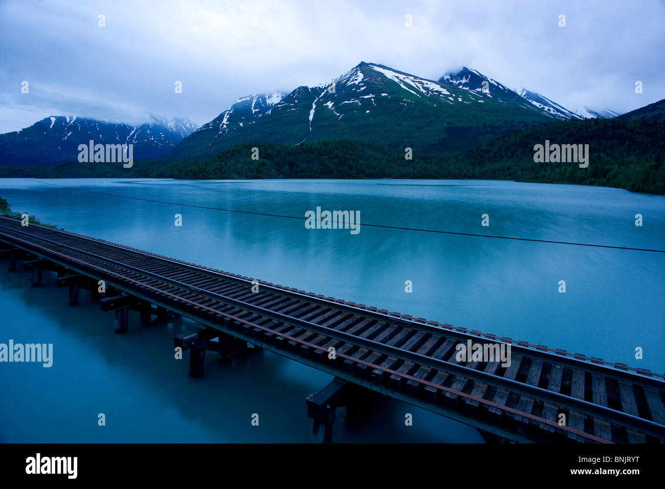Vagt lake Railroad Tracks and Mountains of the Chugach National Forest Alaska Stock Photo