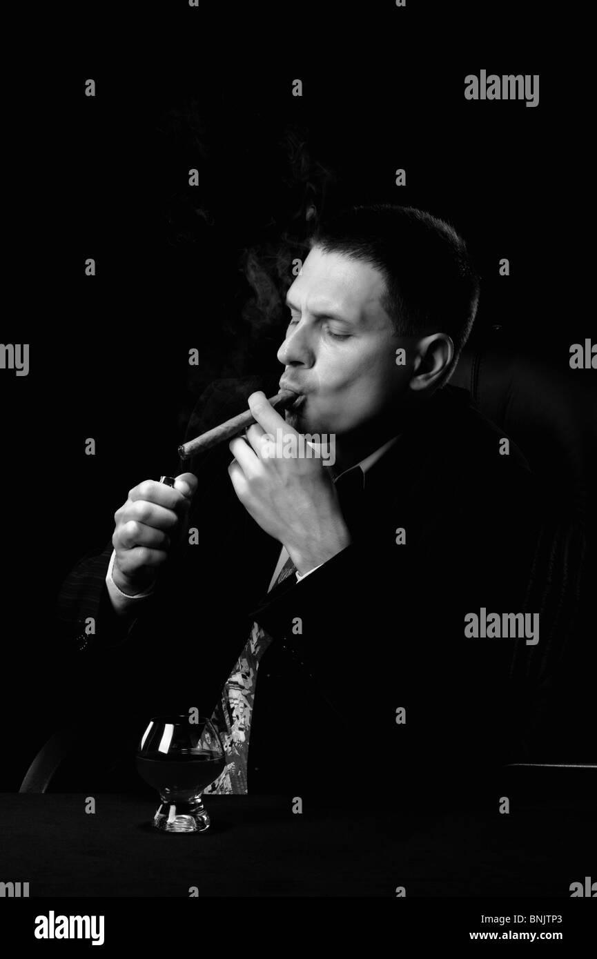 black and white cigarette photo | A close up picture of a lit cigarette in a Cigarette cigarette Black and White