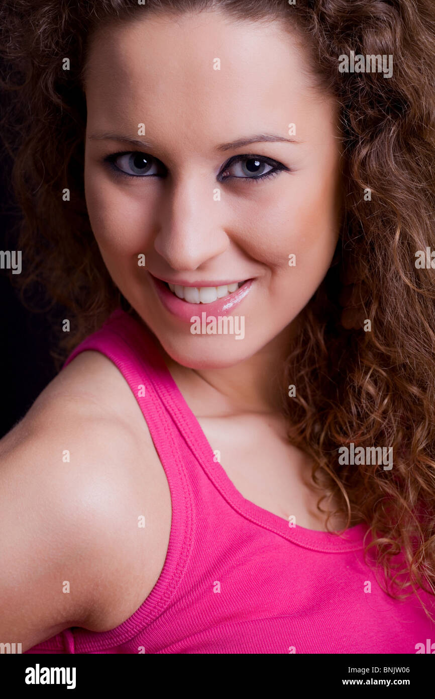 young beautiful brunette portrait against black background Stock Photo ...