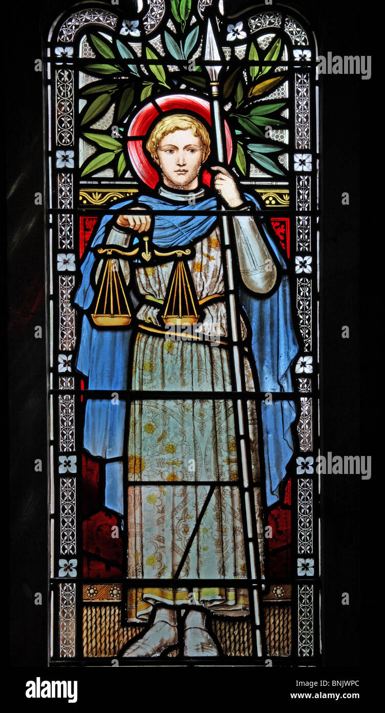 A stained glass window depicting Saint Michael holding a spear and the scales for weighing souls, Church of St Laurence, Lighth Stock Photo