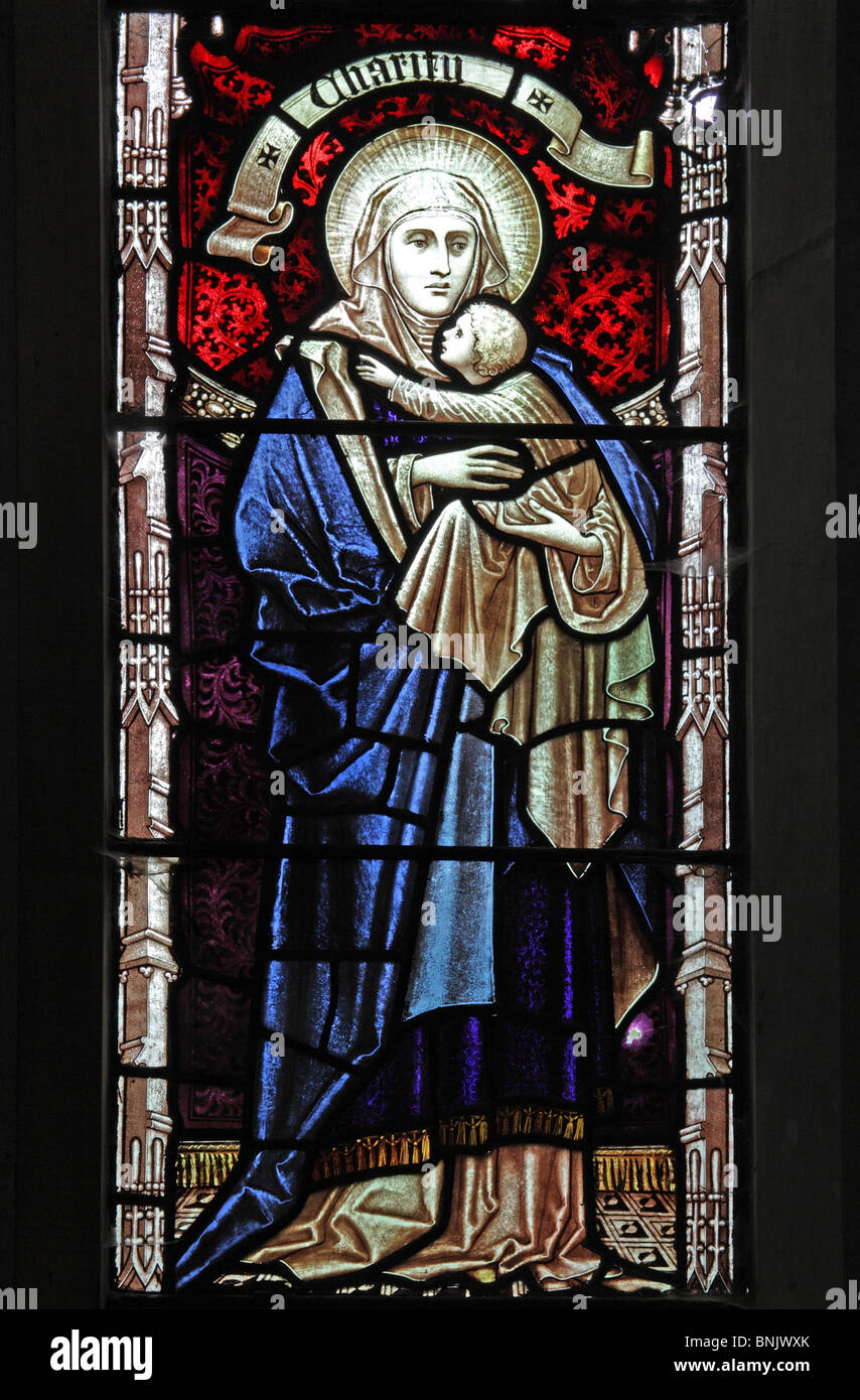 A stained glass window depicting Charity, Parish Church of St James the Great, Snitterfield; Artist Edward Frampton of London Stock Photo