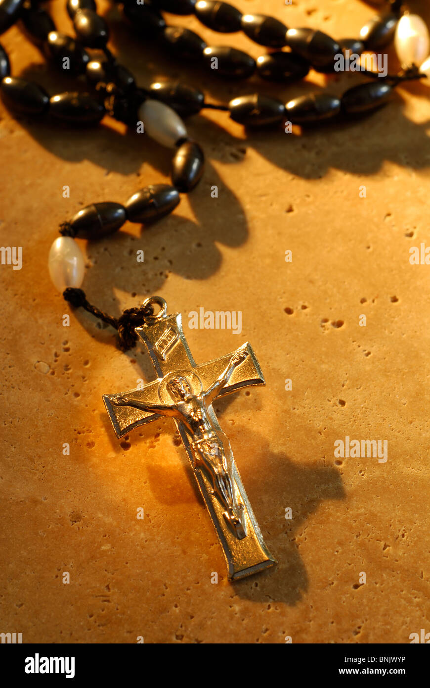 Traditional Metal Crucifix Rosaries Beads On A Stone Background Stock Photo